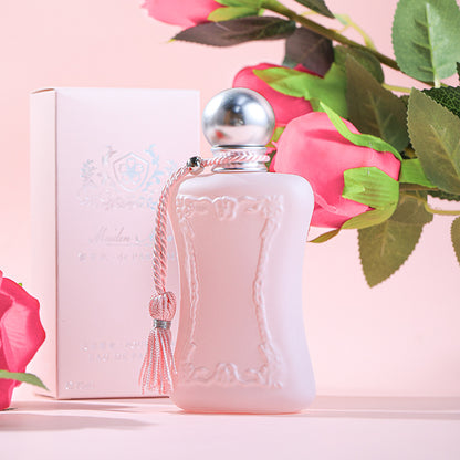 Pink Velvet Luxury Perfume bottle with elegant design against a soft pink background.