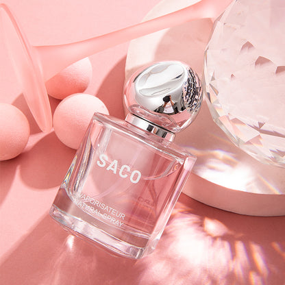 SACO Perfume bottle displayed elegantly on a pink background, showcasing its luxury signature scent.