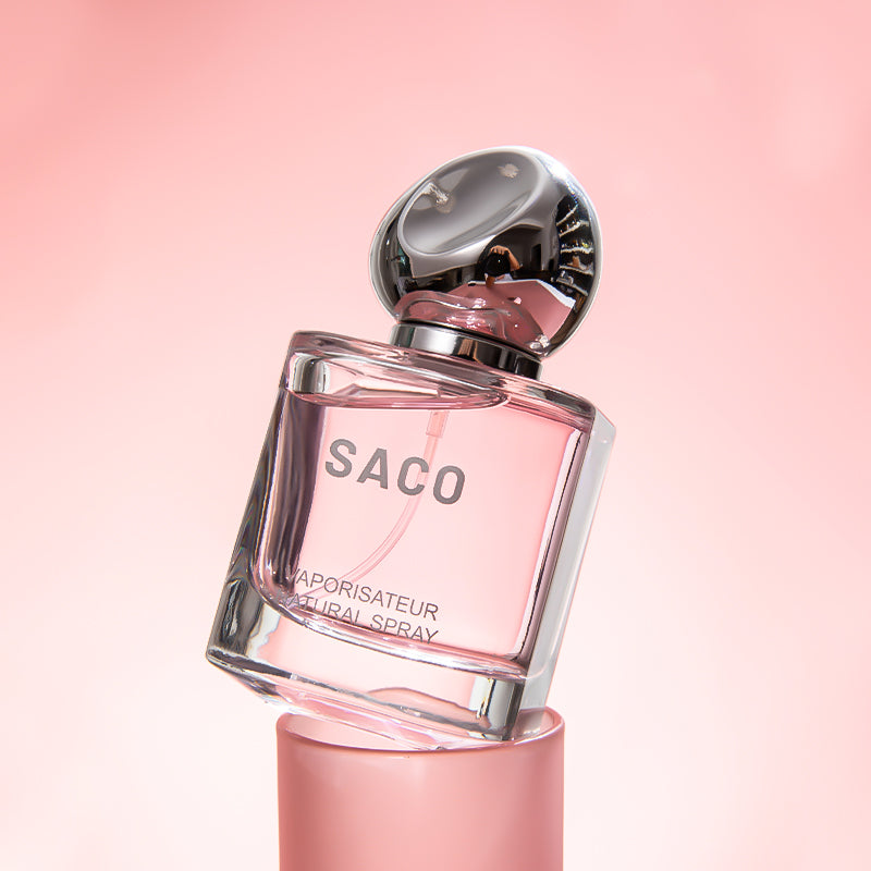SACO Perfume bottle displayed elegantly on a pink background, showcasing its luxury signature scent.