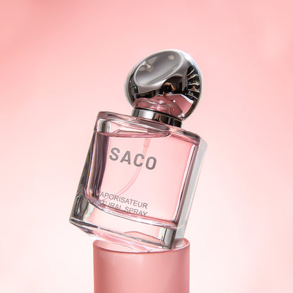 SACO Perfume bottle displayed elegantly on a pink background, showcasing its luxury signature scent.