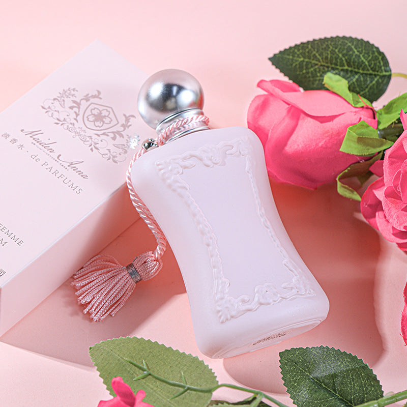 Pink Velvet Luxury Perfume bottle with elegant design against a soft pink background.