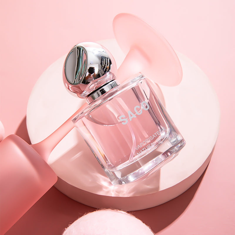 SACO Perfume bottle displayed elegantly on a pink background, showcasing its luxury signature scent.