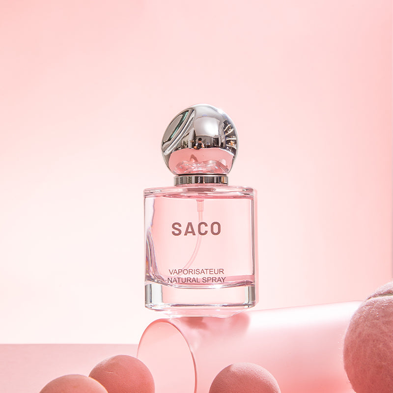 SACO Perfume bottle displayed elegantly on a pink background, showcasing its luxury signature scent.