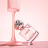 SACO Perfume bottle with elegant design and pink liquid, showcasing long-lasting luxury scent.